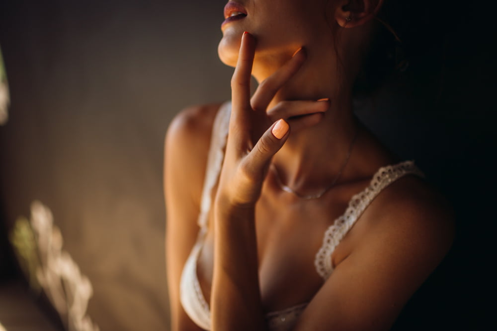 woman white lingerie touches her neck tender