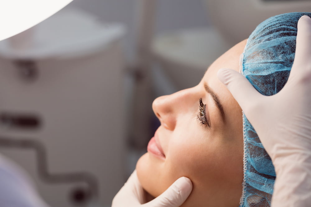 doctor examining womans face cosmetic treatment 1